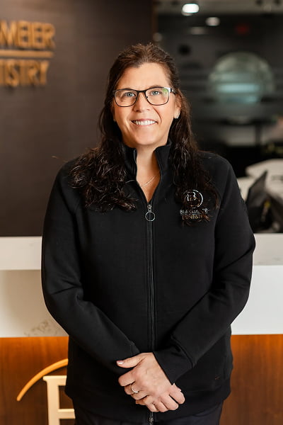 Angie Dental Hygienist at Burgmeier Dentistry in Mason City smiling in her black uniform