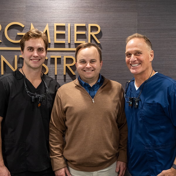 Three doctors smiling
