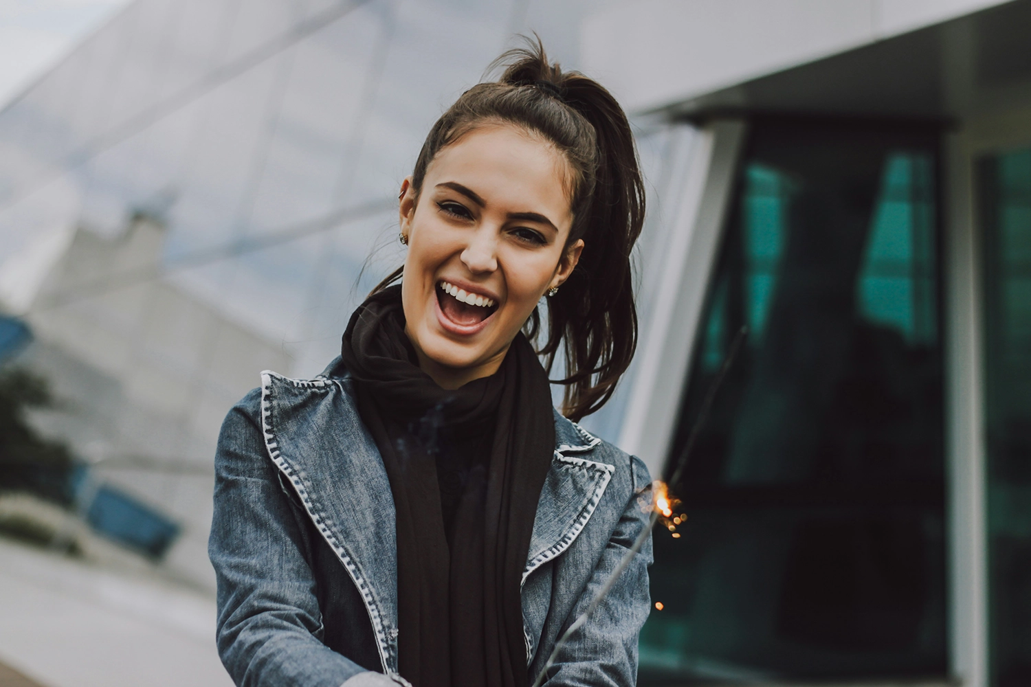 Portrait of a smiling woman wearing a black turtleneck, exuding warmth and friendliness