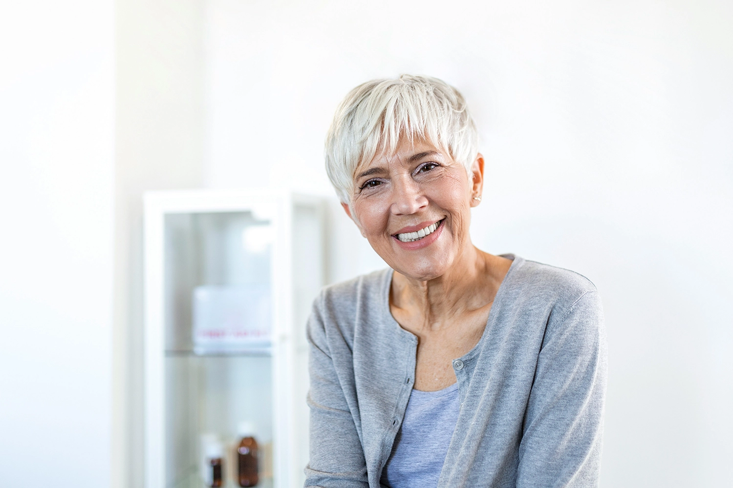 Mature woman sitting in a chair and smiling